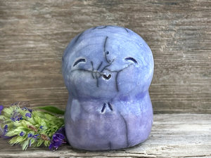 A smiley and loving Jizo Shinto raku ceramic sculpture talisman glazed in a bottom-to-top gradient of violet to blue. It has a kind, gentle face and is a wonderful smooth shape to hold in the hand.