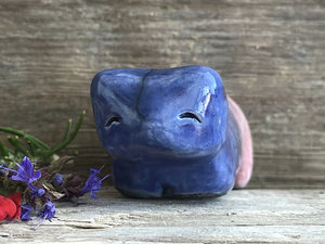 Ceramic raku bear kami sculpture glazed in a front-to-back gradient of indigo blue to soft red-pink. It has a kind, gentle face.