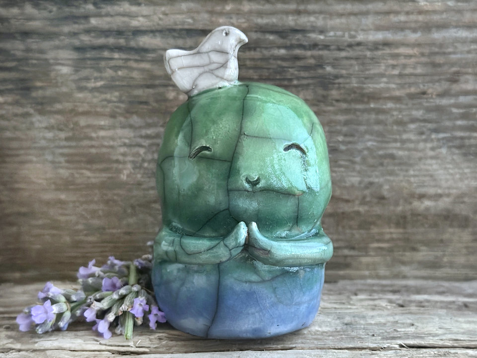 Shinto Jizo nature spirit guardian ceramic statue glazed in a bottom-to-top gradient of blue and green with a happy, smiley face, little praying hands, and a sweet white bird on his head.