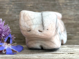 Little raku ceramic cat spirit kami sculpture glazed in pale orange and white and with a kind, gentle face.