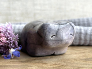 Ceramic raku bear kami sculpture glazed in soft grey violet. It has a kind, gentle face and is a little chonky.