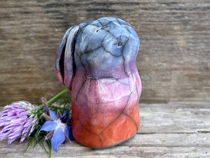 Raku ceramic usagi rabbit kami nature spirit glazed in a bottom-to-top gradient of burnt orange to mauve to indigo-violet. Its ears are folded down its back, and it has a kind, gentle face.