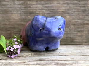 Ceramic raku bear kami sculpture glazed in a front-to-back gradient of indigo blue to soft red-pink. It has a kind, gentle face.