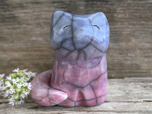 a calm and gentle Shinto Inari kitsune fox kami spirit ceramic raku statue glazed in a bottom-to-top gradient of mauve to purple to blue. its tail is curled around its body on its right side.