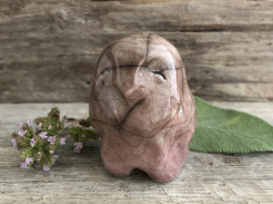 Raku ceramic standing owl / bird sculpture. He is glaze in a gradient from soft warm orange mauve to soft warm mauve brown from bottom to top. He has a kind, gentle face.