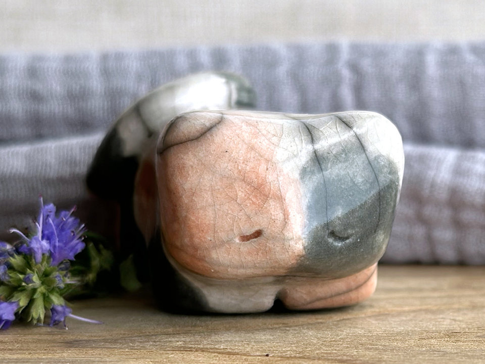 Little raku ceramic cat spirit kami sculpture glazed in a calico pattern (soft red-orange, grey, and white) and with a kind, gentle face.