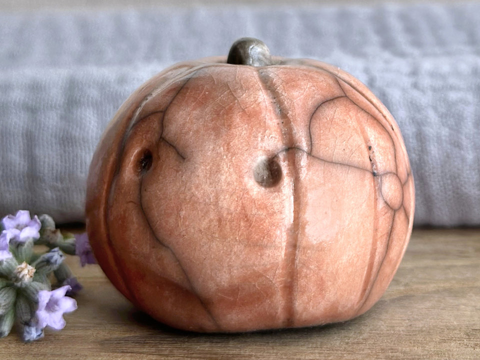 Slightly suspicious rustic pumpkin guardian sculpture for Halloween, Samhain, autumn, fall