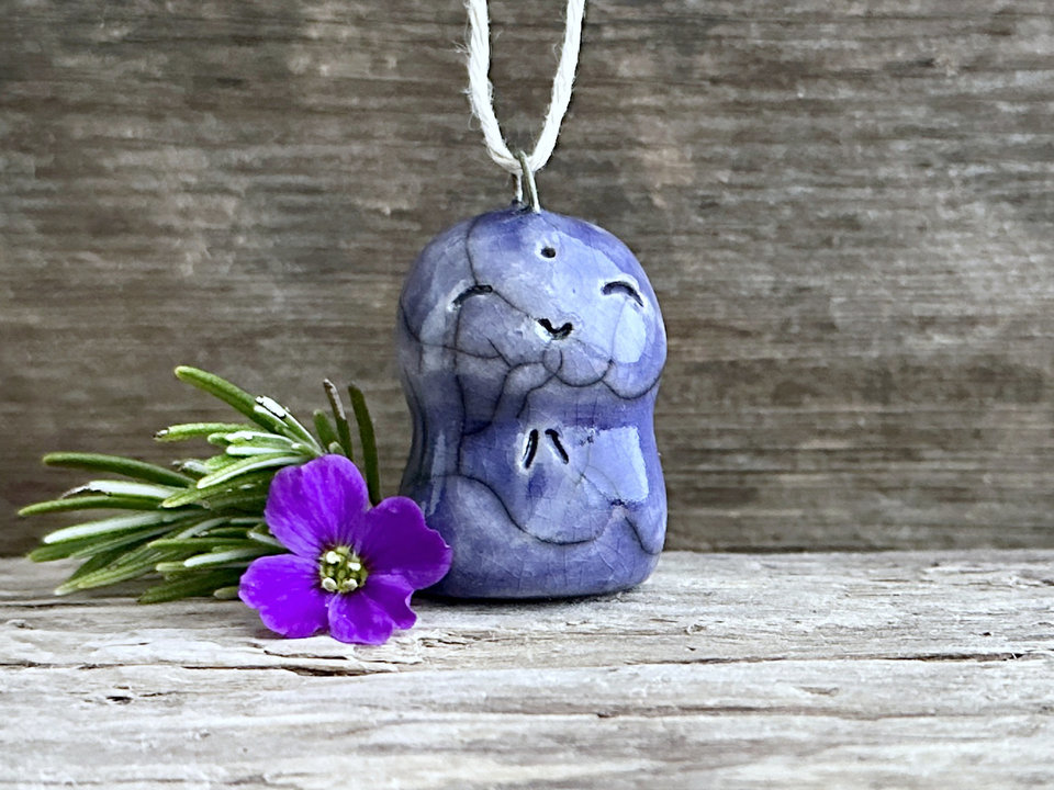 raku ceramic smiley Jizo pendant, glazed in indigo violet and strung on adjustable eco hemp cord.