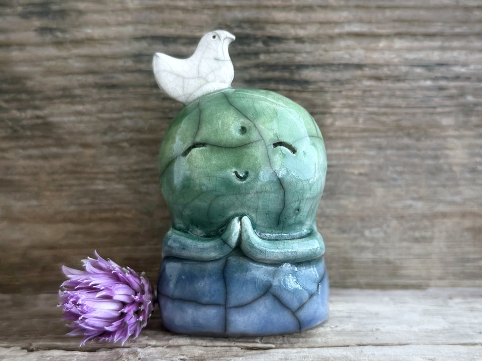 Shinto Jizo nature spirit guardian ceramic statue glazed in a bottom-to-top gradient of blue and green with a happy, smiley face, little praying hands, and a sweet white bird on his head.