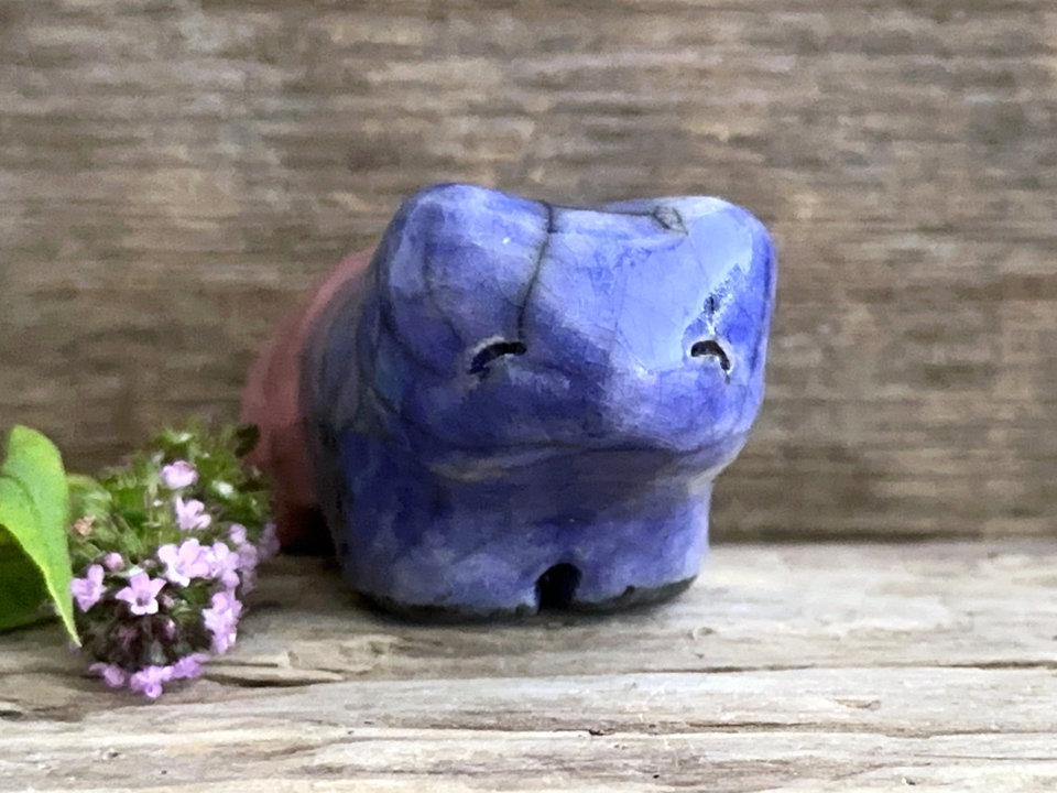 Ceramic raku bear kami sculpture glazed in a front-to-back gradient of indigo blue to soft red-pink. It has a kind, gentle face.