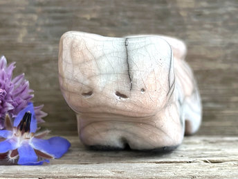 Little raku ceramic cat spirit kami sculpture glazed in pale orange and white and with a kind, gentle face.
