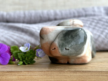 Little raku ceramic cat spirit kami sculpture glazed in a calico pattern (warm orange, grey, and white) and with a kind, gentle face.