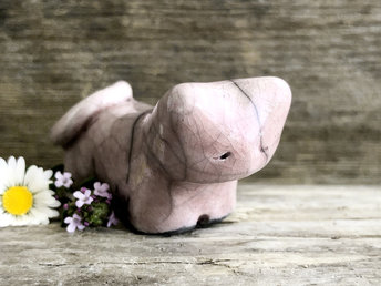 Little raku ceramic cat spirit kami sculpture glazed in a pale red-pink colour and with a kind, gentle face.