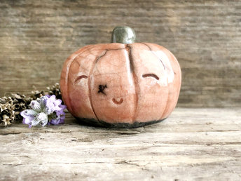 Raku ceramic orange pumpkin nature spirit kami sculpture with a very happy, smiley face.