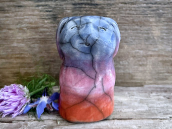 Raku ceramic usagi rabbit kami nature spirit glazed in a bottom-to-top gradient of burnt orange to mauve to indigo-violet. Its ears are folded down its back, and it has a kind, gentle face.