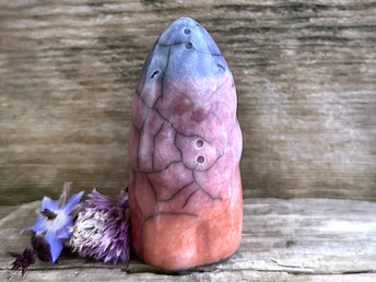 raku ceramic sculpture of a spirit of evening: it looks a little like a tall, upright bird (maybe?) and is glazed in a bottom-to-top gradient of burnt orange to mauve to soft indigo violet. it looks kind, wise, gentle, and magical.