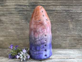 raku ceramic sculpture of a spirit of evening: it looks a little like a tall, upright bird (maybe?) and is glazed in a top-to-bottom gradient of burnt orange to mauve to violet to deep blue. it looks kind, wise, gentle, and magical.