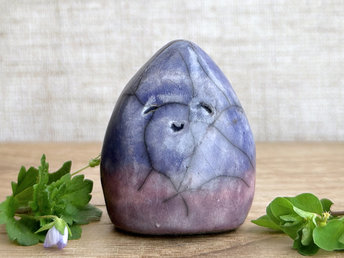 raku ceramic gnome spirit glazed in a bottom-to-top gradient of purple to indigo violet. it has a gentle, kind face.