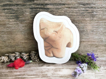 a sticker of a raku ceramic kitsune fox sculpture. it's a pale peachy orange in colour, and it has a very sweet, gentle face. there is a thin white border all around the image.
